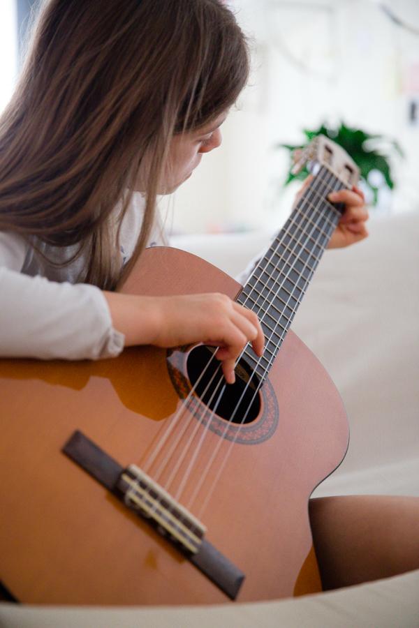 Child playing classical guitar